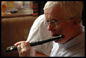 Billy Clifford of Co. Kerry playing a wooden Boehm-system flute. Photo copyright Peter Laban, Miltown Malbay